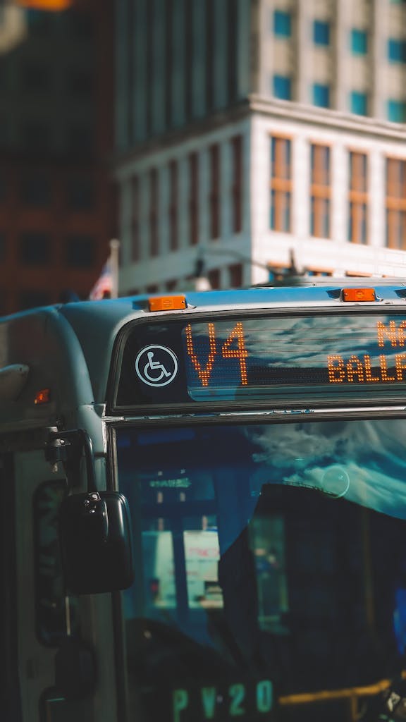 Close-up of a city bus showing route V4 and building backdrop.